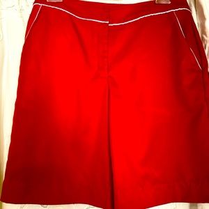 True red Izod shorts with white piping trim.